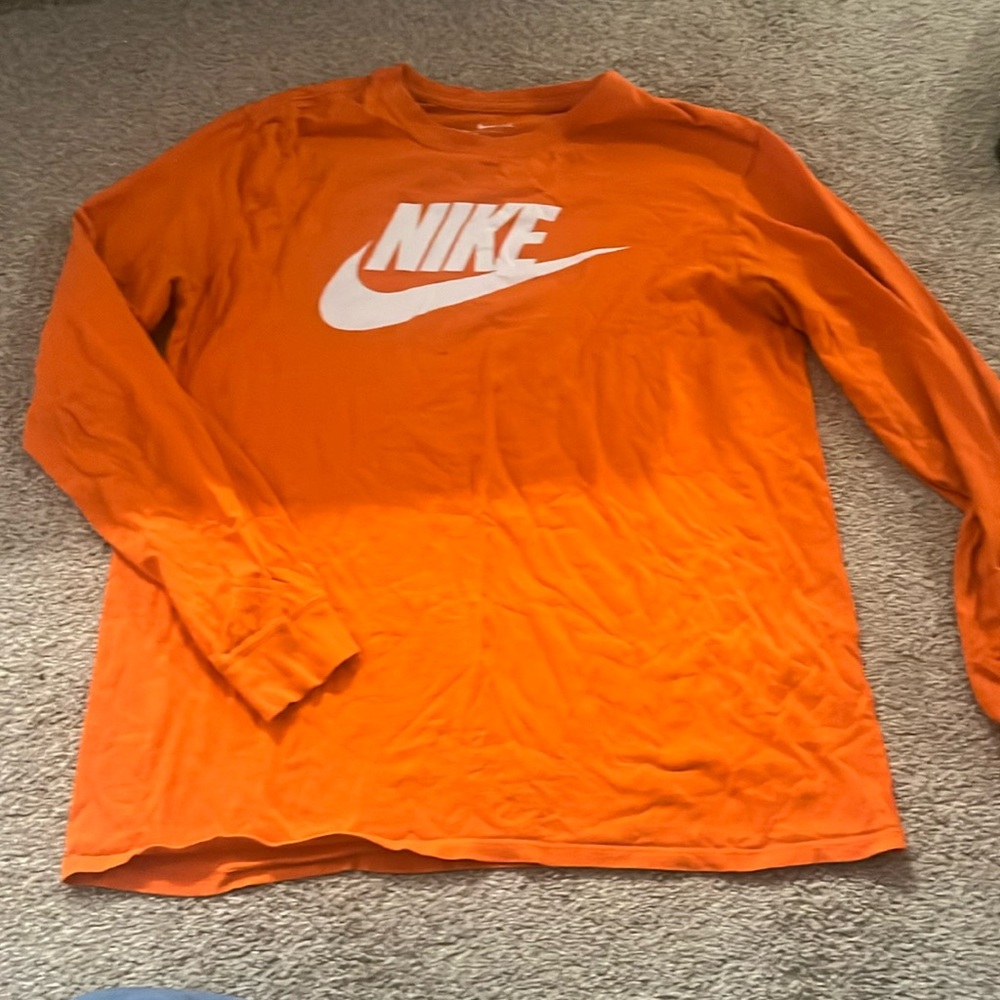 Nike shirt with a small hole under Nike sign